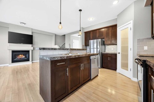214-413 River Avenue, Cochrane, AB - Indoor Photo Showing Kitchen With Fireplace