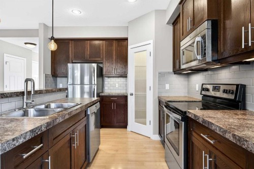 214-413 River Avenue, Cochrane, AB - Indoor Photo Showing Kitchen With Stainless Steel Kitchen With Double Sink With Upgraded Kitchen