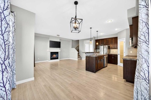 214-413 River Avenue, Cochrane, AB - Indoor Photo Showing Kitchen With Fireplace