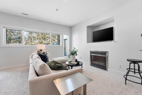 16 Hamptons Cove Nw, Calgary, AB - Indoor Photo Showing Living Room With Fireplace