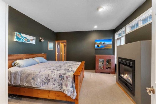 15 Rosery Drive Nw, Calgary, AB - Indoor Photo Showing Bedroom With Fireplace