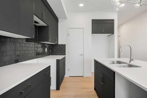 27 Heritage Heath, Cochrane, AB - Indoor Photo Showing Kitchen With Double Sink With Upgraded Kitchen