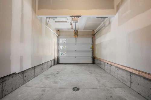 27 Heritage Heath, Cochrane, AB - Indoor Photo Showing Garage