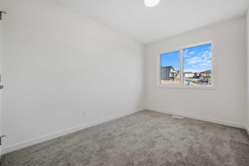 27 Heritage Heath, Cochrane, AB - Indoor Photo Showing Other Room