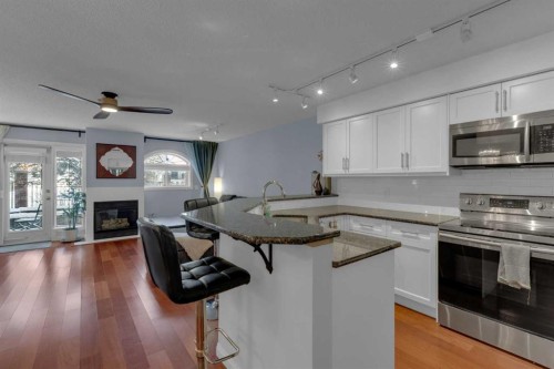 103-923 15 Avenue Sw, Calgary, AB - Indoor Photo Showing Kitchen With Fireplace
