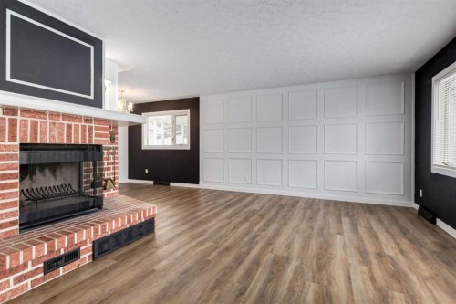 651 84 Avenue Sw, Calgary, AB - Indoor Photo Showing Living Room With Fireplace