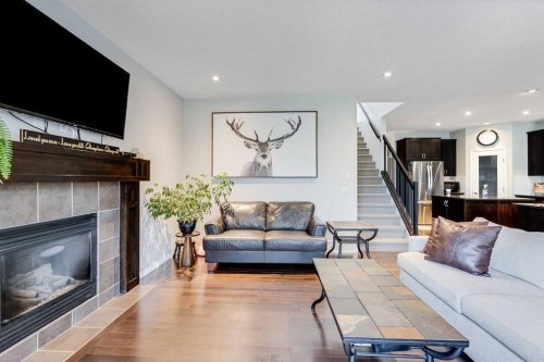 113 Copperpond Bay Se, Calgary, AB - Indoor Photo Showing Living Room With Fireplace