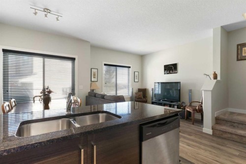 1403 Jumping Pound Common, Cochrane, AB - Indoor Photo Showing Kitchen With Double Sink
