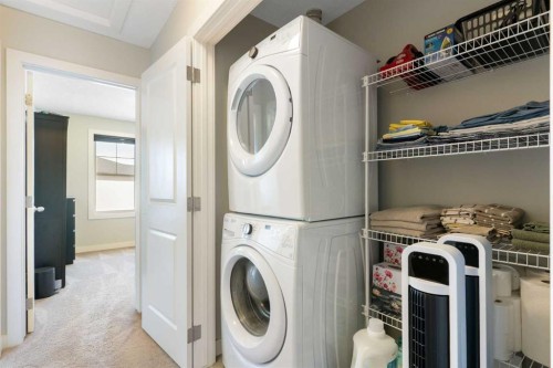 1403 Jumping Pound Common, Cochrane, AB - Indoor Photo Showing Laundry Room