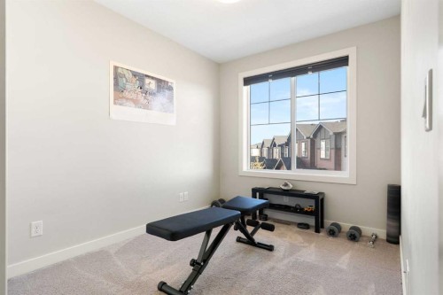 1403 Jumping Pound Common, Cochrane, AB - Indoor Photo Showing Gym Room