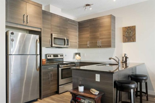 1403 Jumping Pound Common, Cochrane, AB - Indoor Photo Showing Kitchen With Upgraded Kitchen