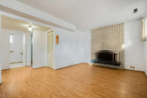 5813 Dalcastle Crescent Nw, Calgary, AB - Indoor Photo Showing Living Room With Fireplace