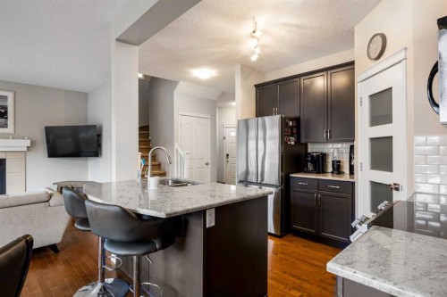 526 New Brighton Drive Se, Calgary, AB - Indoor Photo Showing Kitchen With Fireplace With Double Sink
