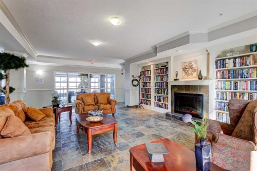 413-15 Everstone Drive Sw, Calgary, AB - Indoor Photo Showing Living Room With Fireplace