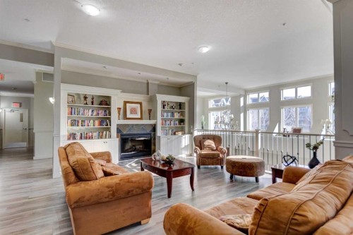 413-15 Everstone Drive Sw, Calgary, AB - Indoor Photo Showing Living Room With Fireplace