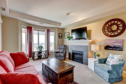 413-15 Everstone Drive Sw, Calgary, AB - Indoor Photo Showing Living Room With Fireplace