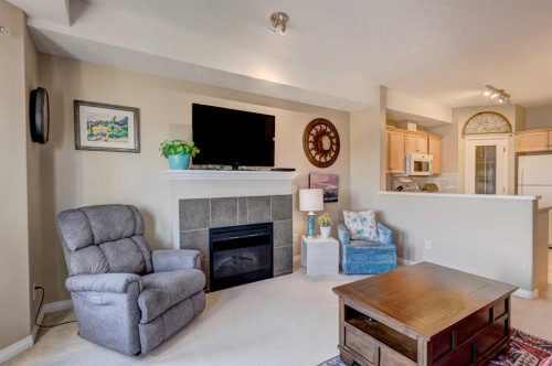 413-15 Everstone Drive Sw, Calgary, AB - Indoor Photo Showing Living Room With Fireplace