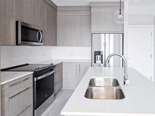 2413-111 Wolf Creek Drive Se, Calgary, AB - Indoor Photo Showing Kitchen With Stainless Steel Kitchen With Double Sink