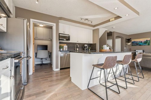 104 Bow Ridge Crescent, Cochrane, AB - Indoor Photo Showing Kitchen With Stainless Steel Kitchen With Upgraded Kitchen