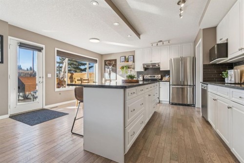 104 Bow Ridge Crescent, Cochrane, AB - Indoor Photo Showing Kitchen With Stainless Steel Kitchen With Upgraded Kitchen