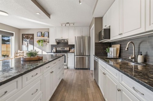 104 Bow Ridge Crescent, Cochrane, AB - Indoor Photo Showing Kitchen With Stainless Steel Kitchen With Double Sink With Upgraded Kitchen