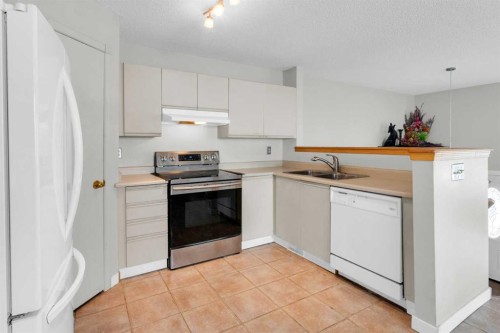 8035 Laguna Way Ne, Calgary, AB - Indoor Photo Showing Kitchen With Double Sink