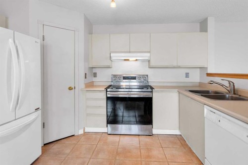 8035 Laguna Way Ne, Calgary, AB - Indoor Photo Showing Kitchen With Double Sink