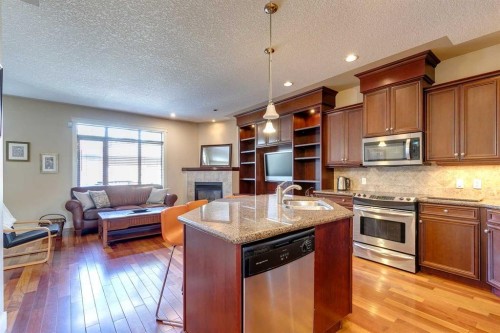 446 18 Avenue Ne, Calgary, AB - Indoor Photo Showing Kitchen With Fireplace With Double Sink