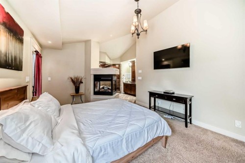 36 Dalrymple Green Nw, Calgary, AB - Indoor Photo Showing Bedroom With Fireplace