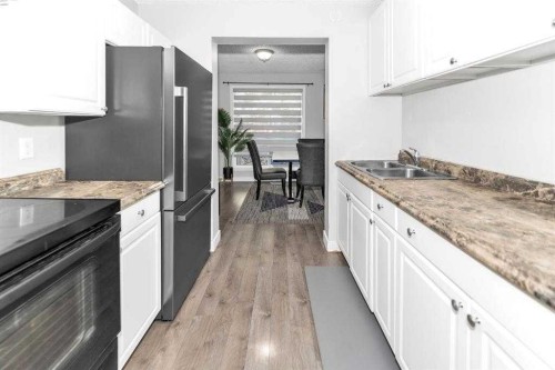 151-6915 Ranchview Drive Nw, Calgary, AB - Indoor Photo Showing Kitchen With Double Sink With Upgraded Kitchen