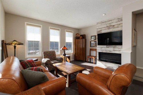 513 Ascot Circle Sw, Calgary, AB - Indoor Photo Showing Living Room With Fireplace