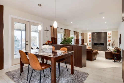 16 Silvercreek Place Nw, Calgary, AB - Indoor Photo Showing Dining Room With Fireplace