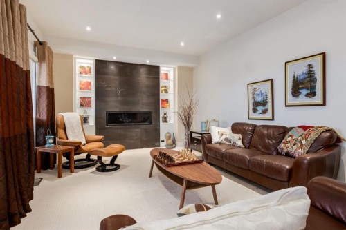 16 Silvercreek Place Nw, Calgary, AB - Indoor Photo Showing Living Room With Fireplace