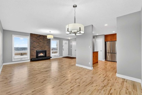 740 Lysander Drive Se, Calgary, AB - Indoor Photo Showing Living Room With Fireplace
