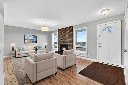 740 Lysander Drive Se, Calgary, AB - Indoor Photo Showing Living Room With Fireplace