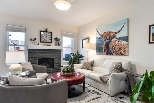 23 Cranbrook Green Se, Calgary, AB - Indoor Photo Showing Living Room With Fireplace