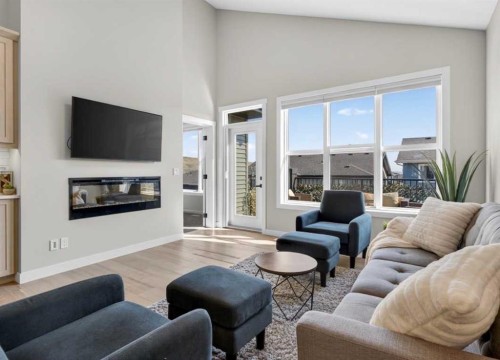 184 Precedence Hill, Cochrane, AB - Indoor Photo Showing Living Room With Fireplace
