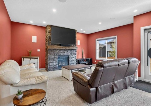184 Precedence Hill, Cochrane, AB - Indoor Photo Showing Living Room With Fireplace