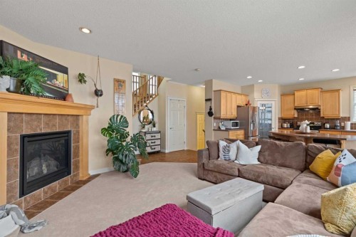 137 Copperleaf Bay Se, Calgary, AB - Indoor Photo Showing Living Room With Fireplace