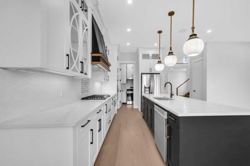 203 Kinniburgh Place, Chestermere, AB - Indoor Photo Showing Kitchen With Double Sink With Upgraded Kitchen