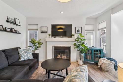 100 Sage Valley Drive Nw, Calgary, AB - Indoor Photo Showing Living Room With Fireplace