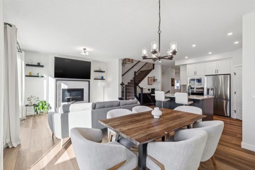 170 Creekstone Path Sw, Calgary, AB - Indoor Photo Showing Dining Room With Fireplace