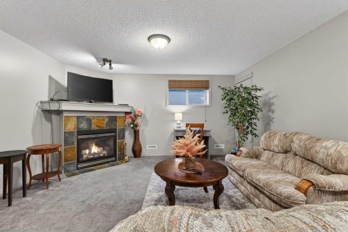 331 Prestwick Heights Se, Calgary, AB - Indoor Photo Showing Living Room With Fireplace