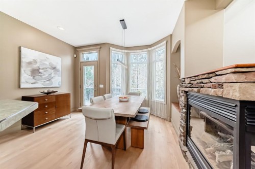 38 Discovery Ridge Green Sw, Calgary, AB - Indoor Photo Showing Dining Room With Fireplace