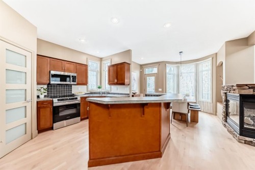 38 Discovery Ridge Green Sw, Calgary, AB - Indoor Photo Showing Kitchen With Fireplace