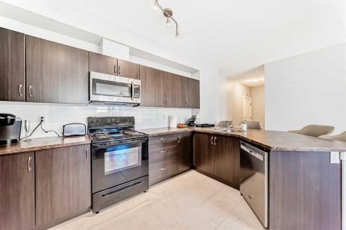 107-100 Cranfield Common Se, Calgary, AB - Indoor Photo Showing Kitchen With Double Sink