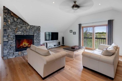 84 Eagle Butte Ranch, Rural Rocky View County, AB - Indoor Photo Showing Living Room With Fireplace