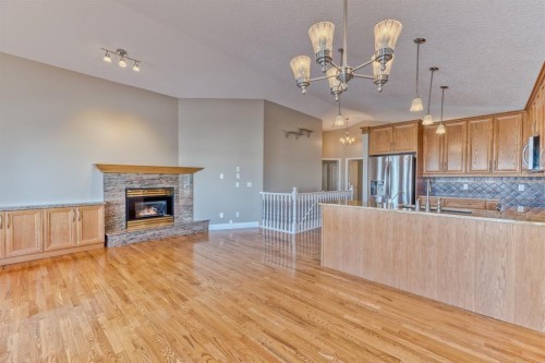 180 Hidden Vale Close Nw, Calgary, AB - Indoor Photo Showing Other Room With Fireplace