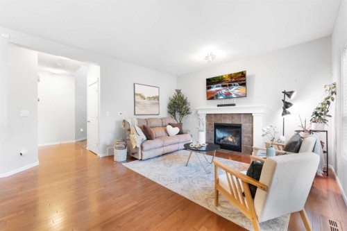 295 Prairie Springs Crescent Sw, Airdrie, AB - Indoor Photo Showing Living Room With Fireplace