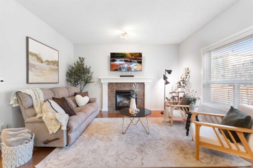 295 Prairie Springs Crescent Sw, Airdrie, AB - Indoor Photo Showing Living Room With Fireplace